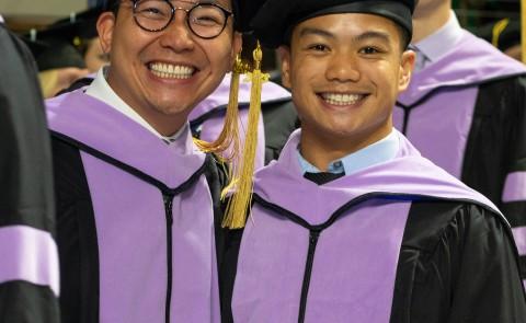 UNE graduates smile for the camera at Commencement