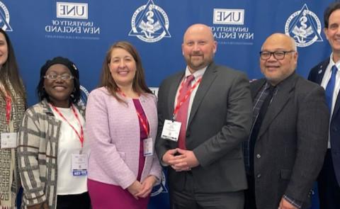 Several UNE dental medicine educators pose for a photo